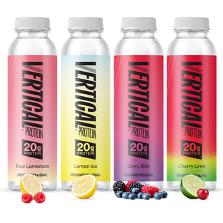 Four Vertical Protein drink bottles arranged side by side on a white background, each with a different flavor color label and fruit garnish below: Razz Lemonade with pink, Lemon Ice with pale yellow, Berry Blitz with pink-purple, and Cherry Lime with red-green. Visible brand text on all bottles reads VERTICAL PROTEIN 20g protein.