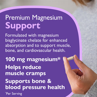 A hand holds a small capsule next to a purple informational card that reads 'Premium Magnesium Support' with text about magnesium bisglycinate chelate and benefits, including 100 mg magnesium and support for muscle cramps, bone, and cardiovascular health.
