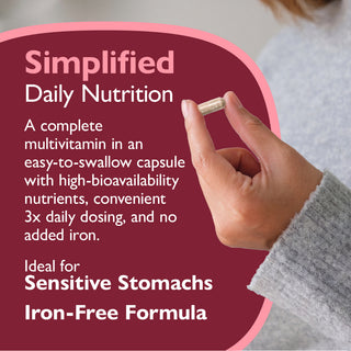 Multivitamin capsule being held with promotional text about simplified daily nutrition on a red background.