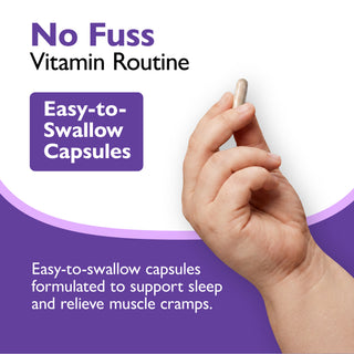 A hand holding a small beige capsule against a white and purple promotional graphic that reads 'No Fuss Vitamin Routine' and 'Easy-to-Swallow Capsules.'.